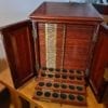 Antique Coin Cabinet A stunning mahogany coin cabinet, ex Baldwin values, size approx 30 x 39 x 30cm, comprising 27 trays double-pierced