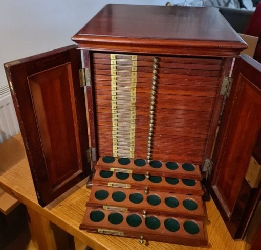 Antique Coin Cabinet A stunning mahogany coin cabinet, ex Baldwin values, size approx 30 x 39 x 30cm, comprising 27 trays double-pierced