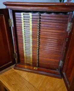 Antique Coin Cabinet A stunning mahogany coin cabinet, ex Baldwin values, size approx 30 x 39 x 30cm, comprising 27 trays double-pierced